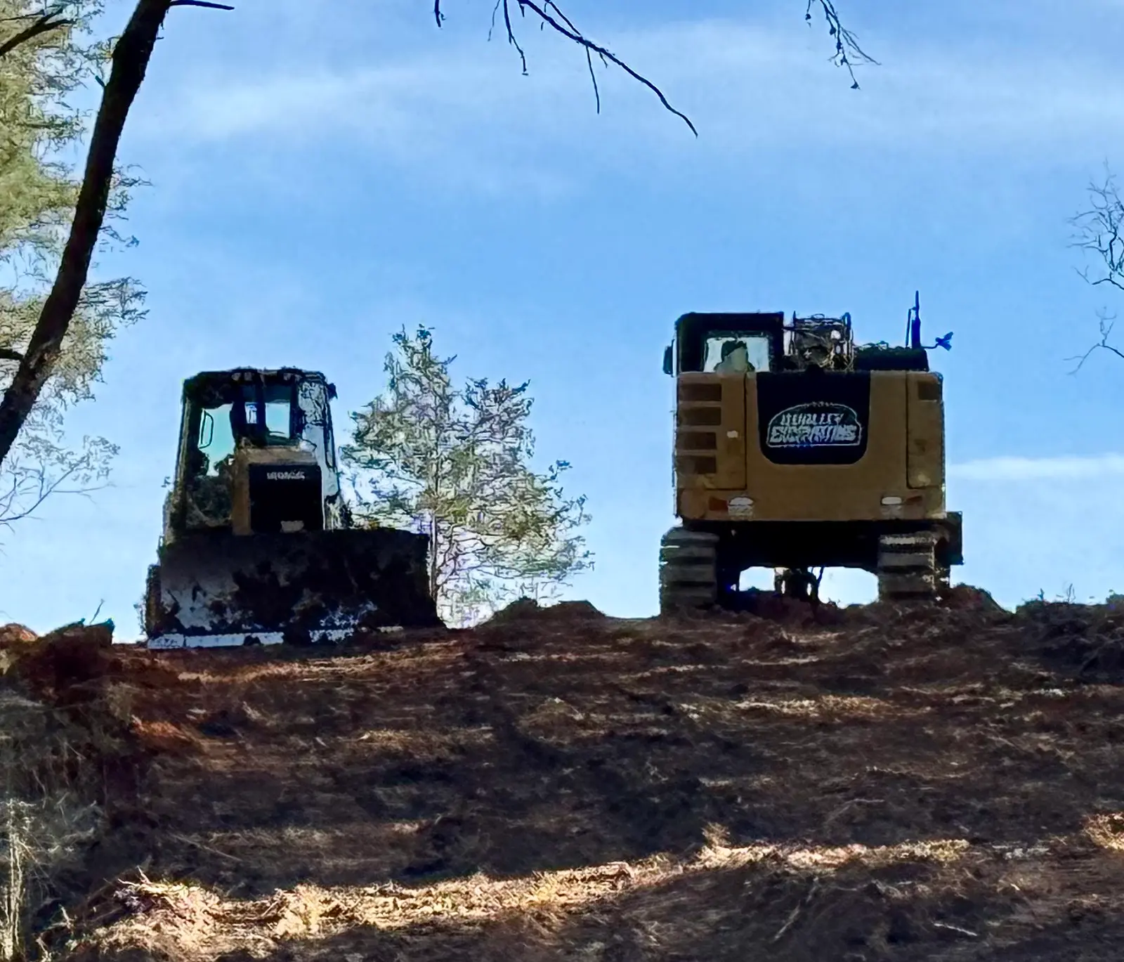 Prepared dirt work area with heavy-equipment tracks
