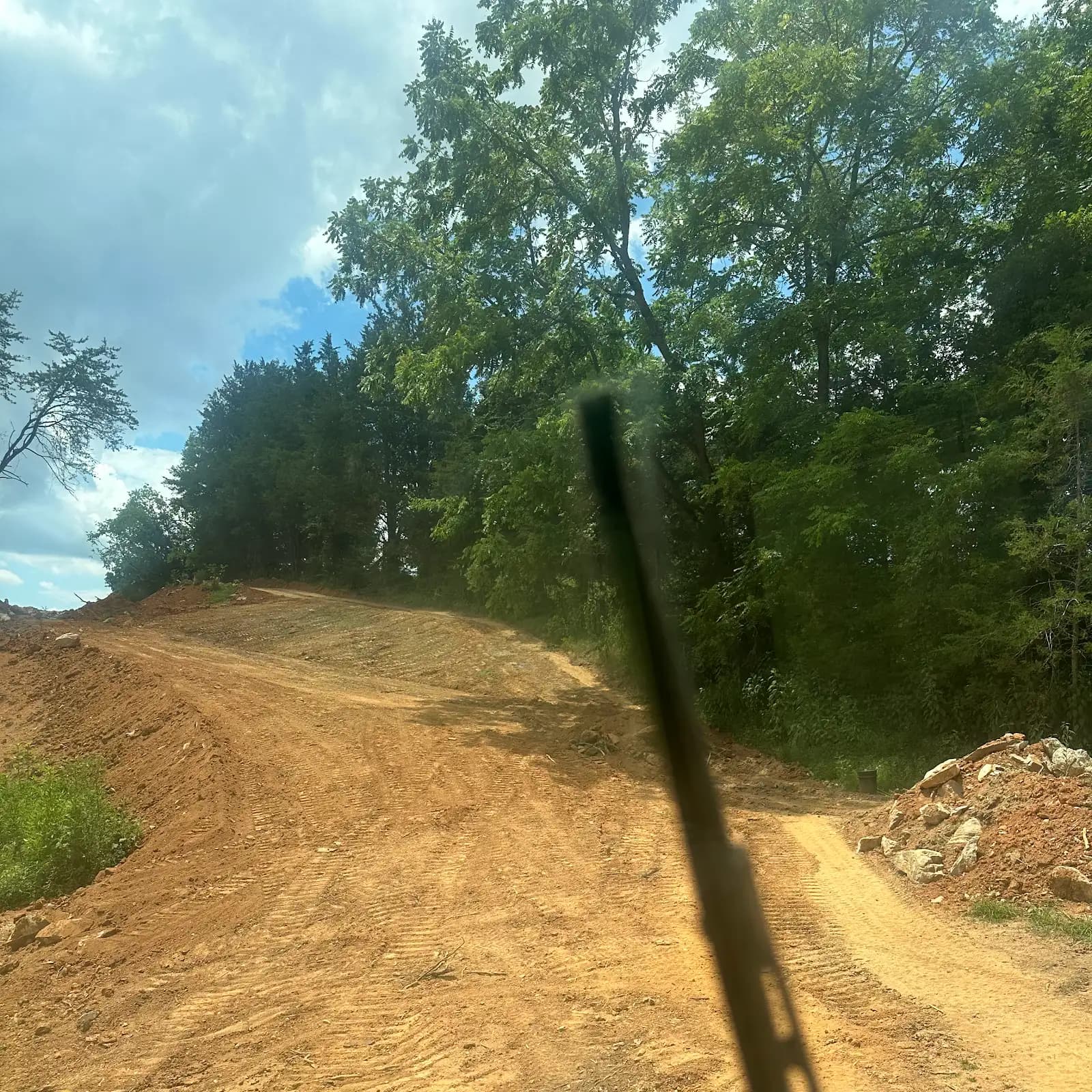 Graded access route through a wooded property